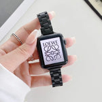 steel replacement watchband for Apple Watch on a wrist, displaying a stylish black strap with a screen showing LOEWE logo.