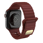 Breathable silicone watch strap for Apple Watch in maroon color on a black watch.
