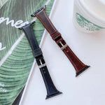 Double-sided genuine leather apple watch band replacement strap in black and brown colors on a stylish background.