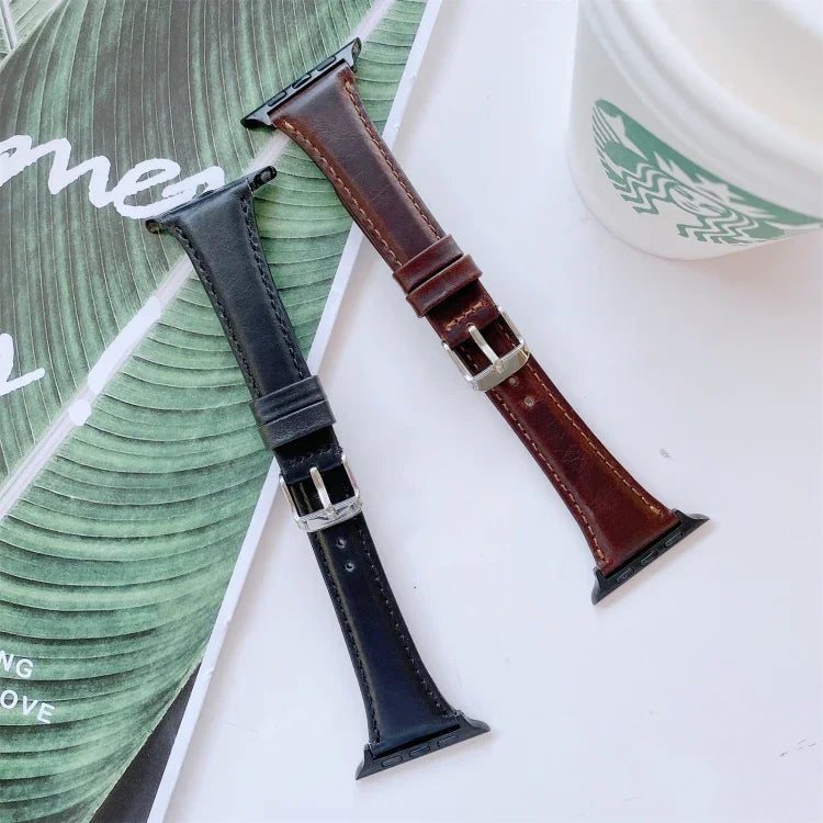 Double-sided genuine leather apple watch band replacement strap in black and brown colors on a stylish background.